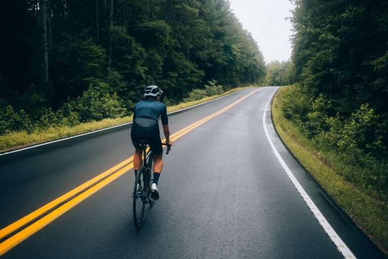 cyclist man riding bike road